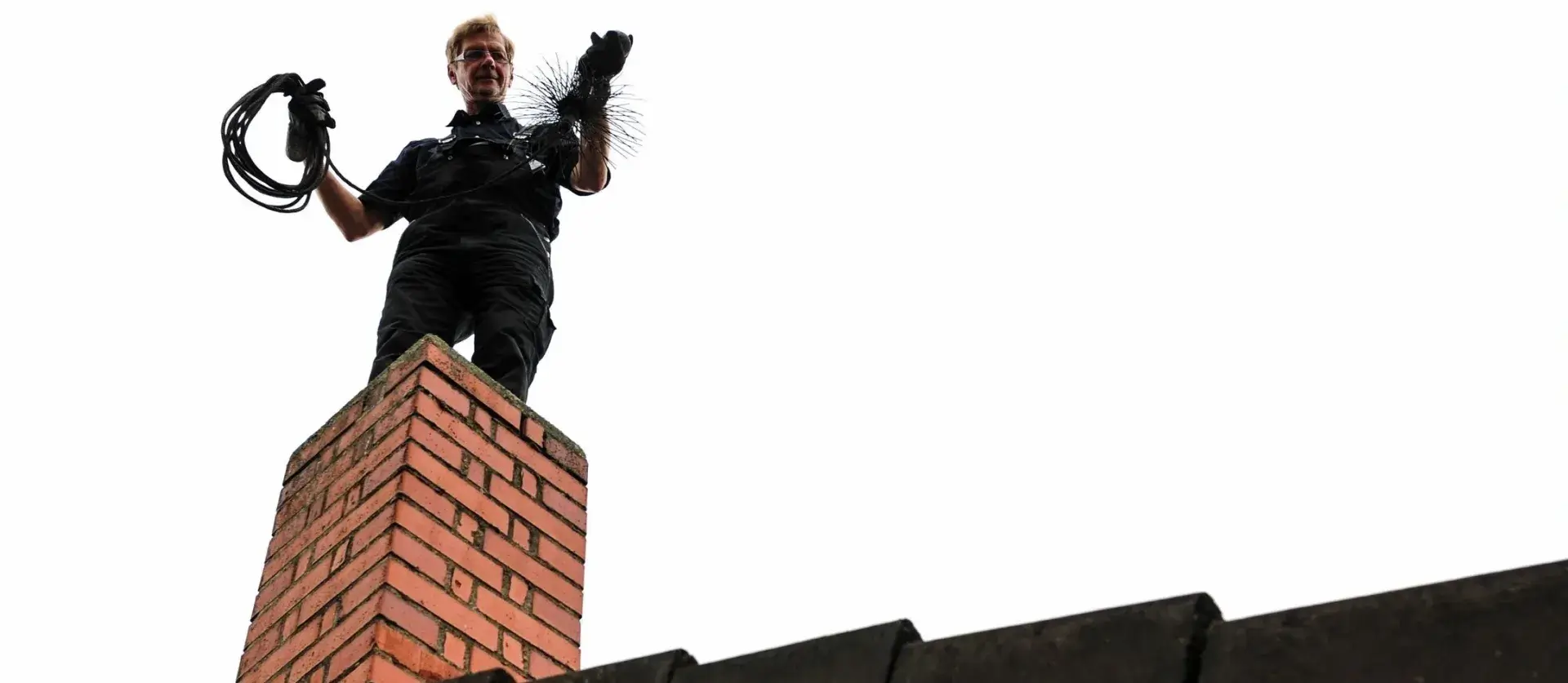 A man standing on top of a brick wall.